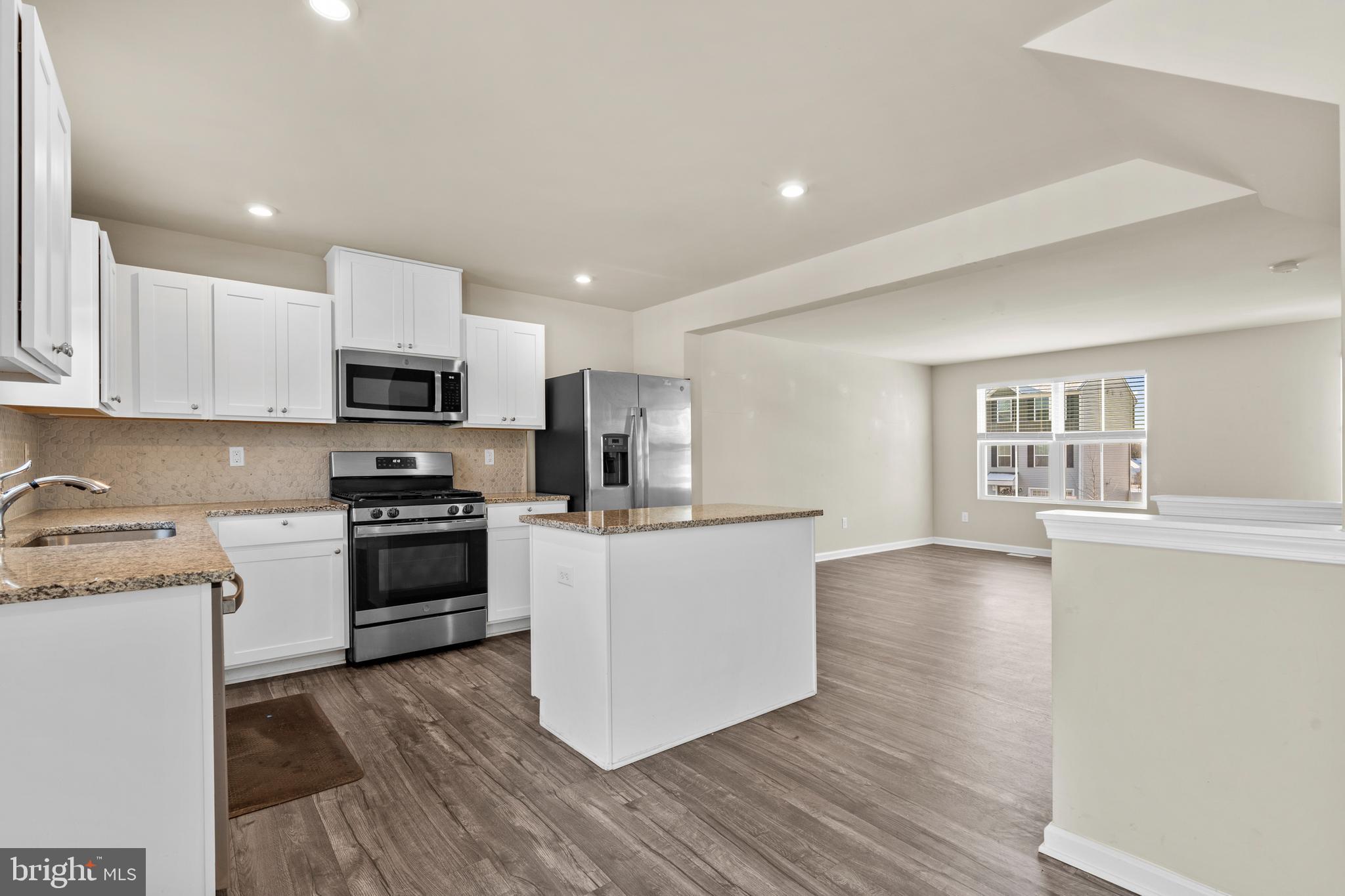 117 Comfort Road Williamstown, NJ 08094 - Photo 4 of 23 a kitchen with stainless steel appliances a stove top oven a sink a refrigerator a microwave and cabinets