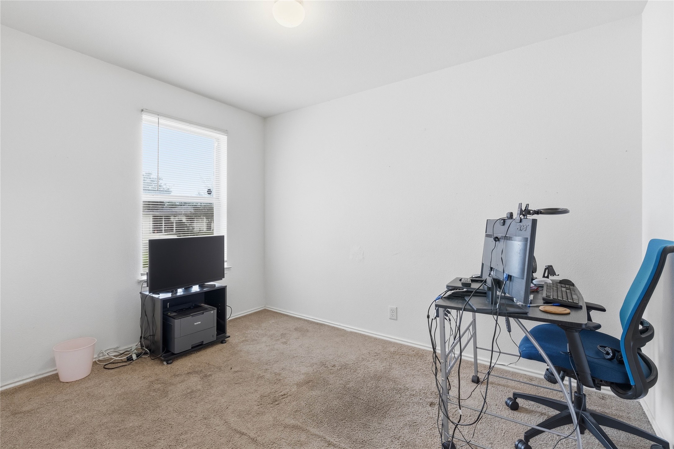 16112 Hamilton Point Circle Manor, TX 78653 - Photo 12 of 27 Carpeted room with a single window, white walls, and a ceiling-mounted light fixture