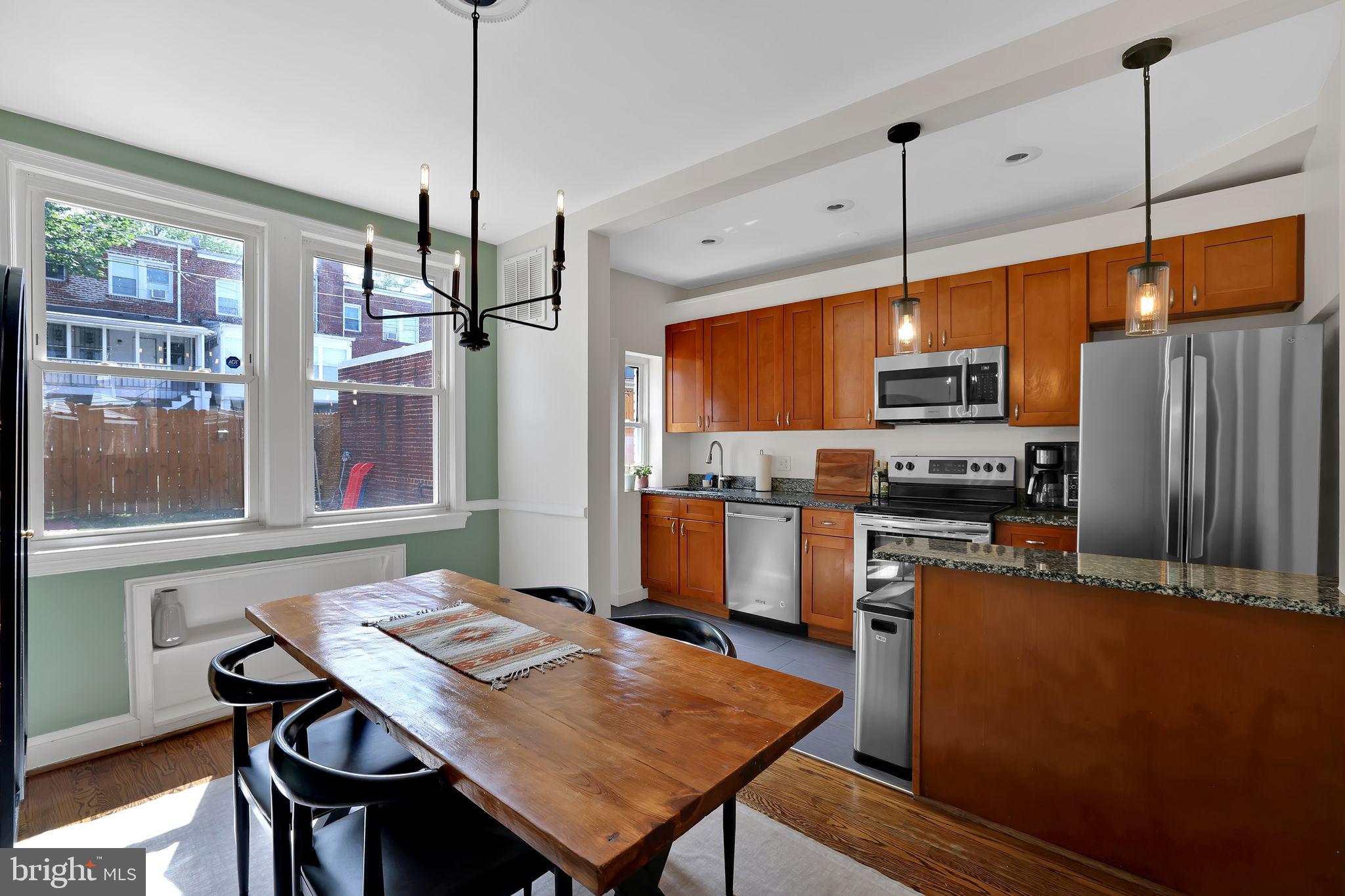 1719 Lyman Place Northeast Washington, DC 20002 - Photo 12 of 32 a kitchen with stainless steel appliances granite countertop a sink a stove and refrigerator
