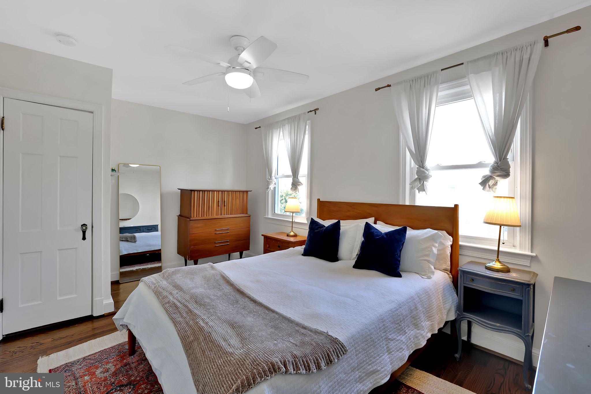 1719 Lyman Place Northeast Washington, DC 20002 - Photo 18 of 32 a bedroom with a bed and wooden floor