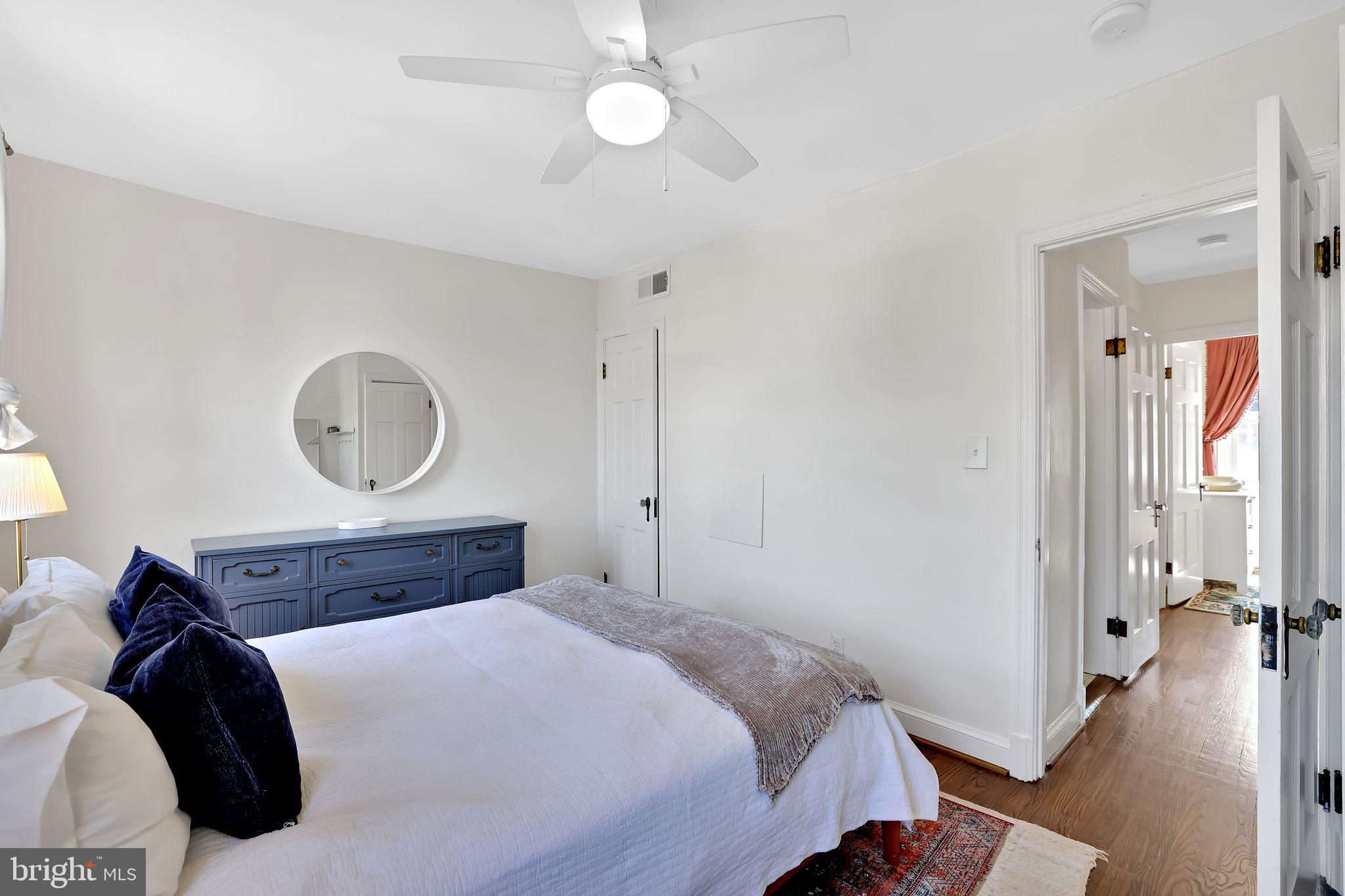 1719 Lyman Place Northeast Washington, DC 20002 - Photo 20 of 32 a bedroom with a large bed and a chandelier
