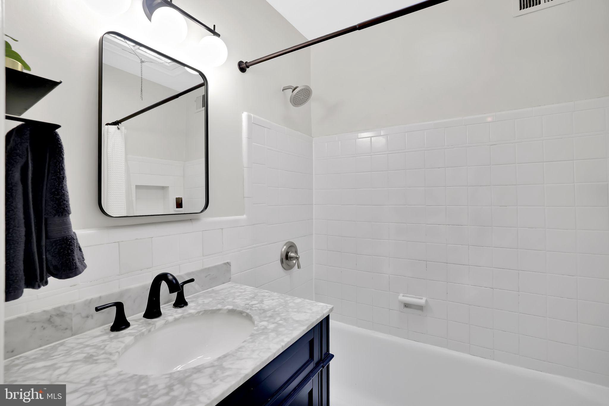 1719 Lyman Place Northeast Washington, DC 20002 - Photo 21 of 32 a bathroom with a sink and a mirror