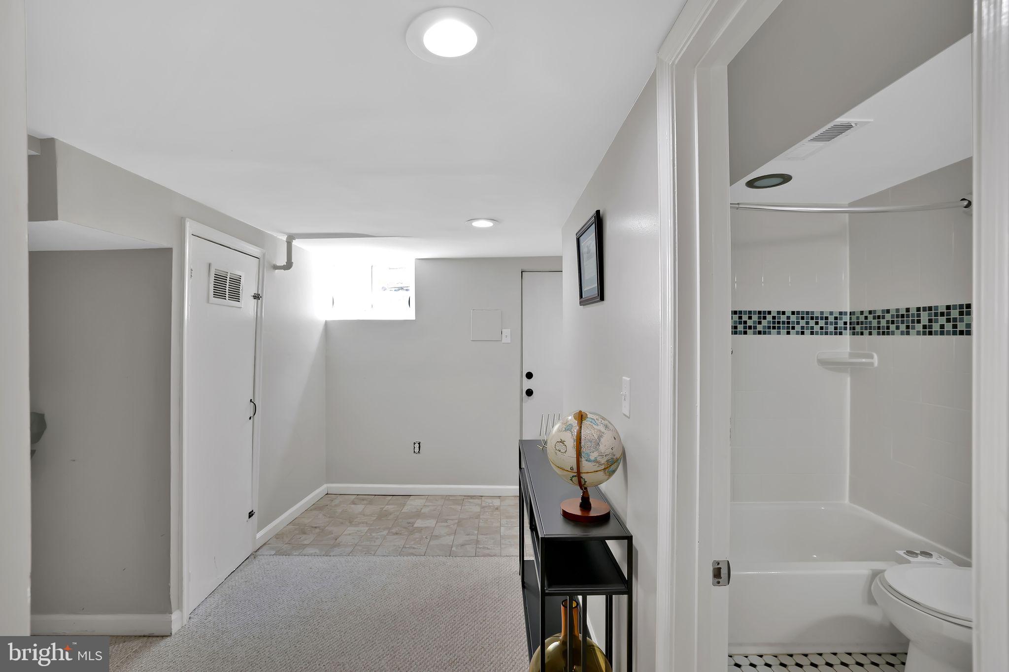 1719 Lyman Place Northeast Washington, DC 20002 - Photo 30 of 32 a bathroom with a granite countertop sink and a mirror