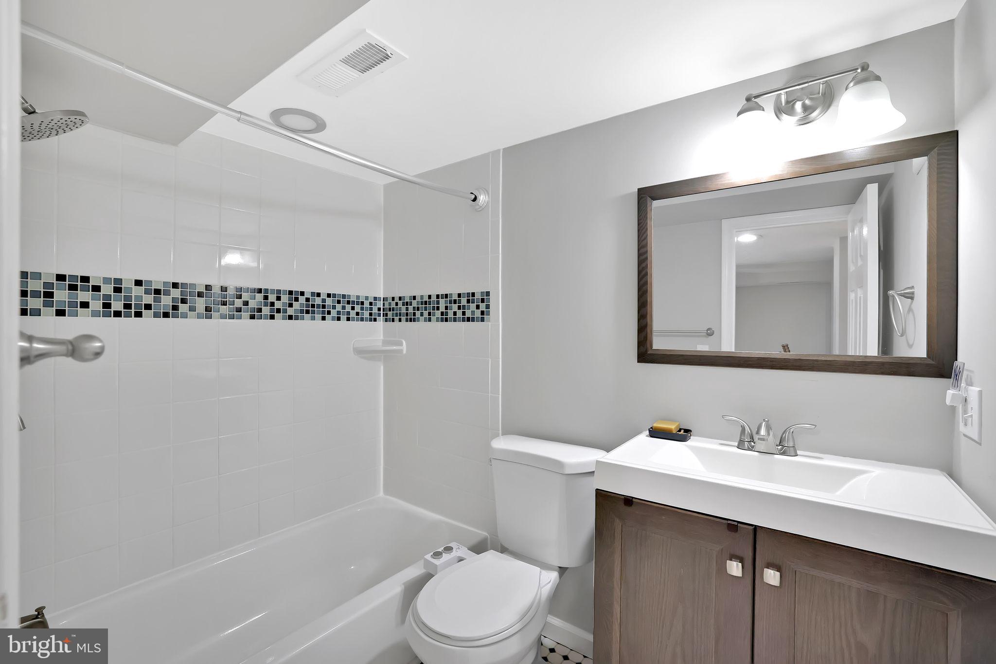 1719 Lyman Place Northeast Washington, DC 20002 - Photo 31 of 32 a bathroom with a sink a toilet a mirror and shower