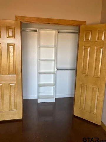 a view of walk in closet with empty racks