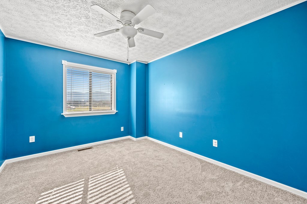2040 Maples Branch Road Sevierville, TN 37876 - Photo 17 of 40 a bedroom with a bed and a ceiling fan