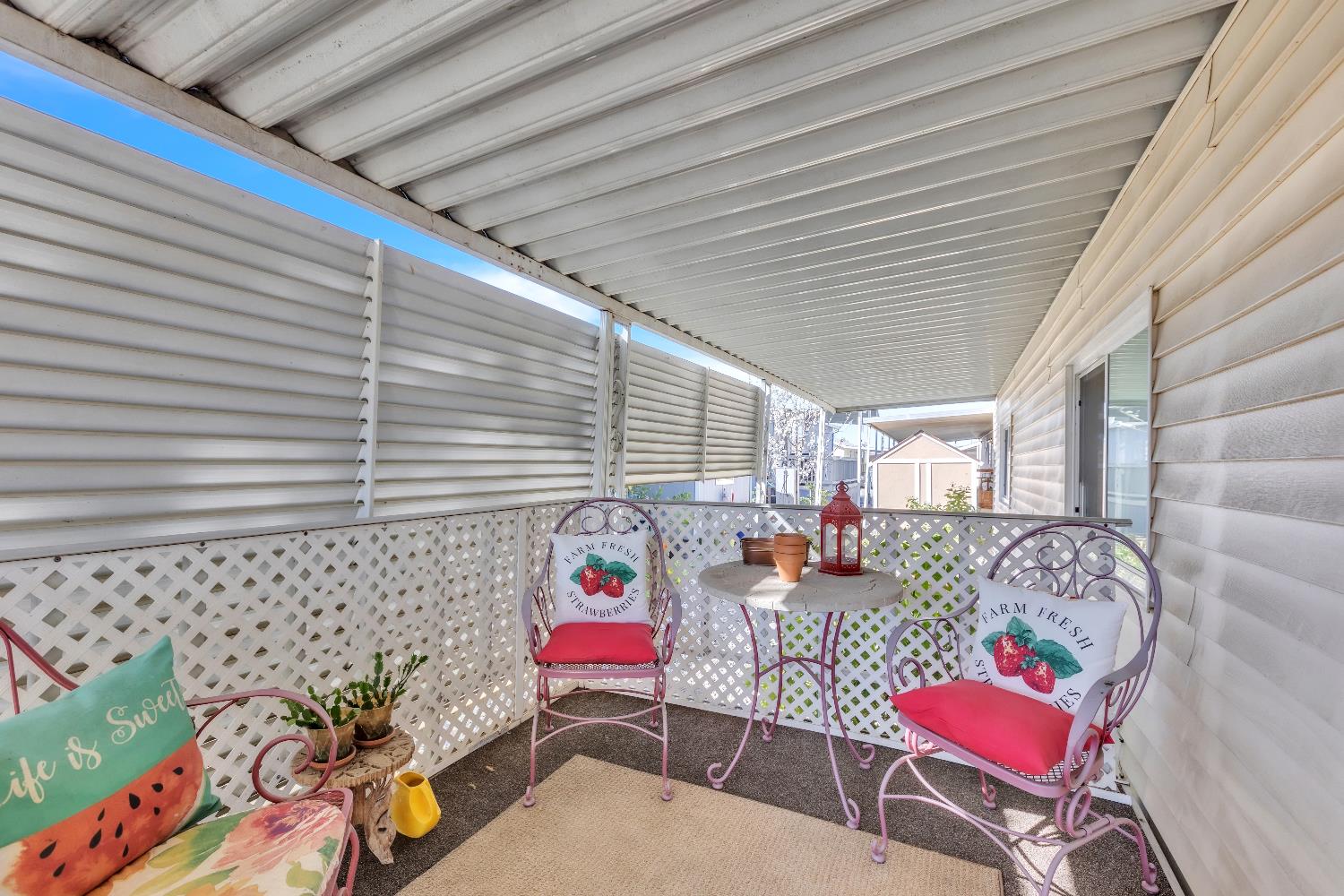 a balcony with furniture and a potted plant