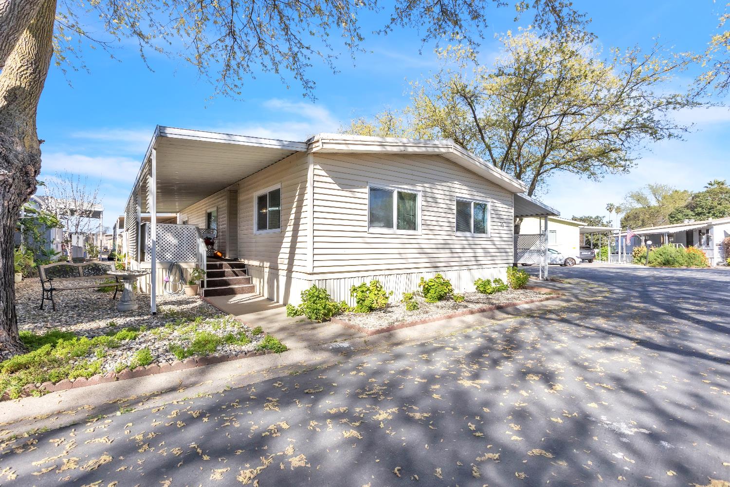 3901 Lake Road, Unit 76 West Sacramento, CA 95691 - Photo 23 of 29 a front view of a house with a yard and garage