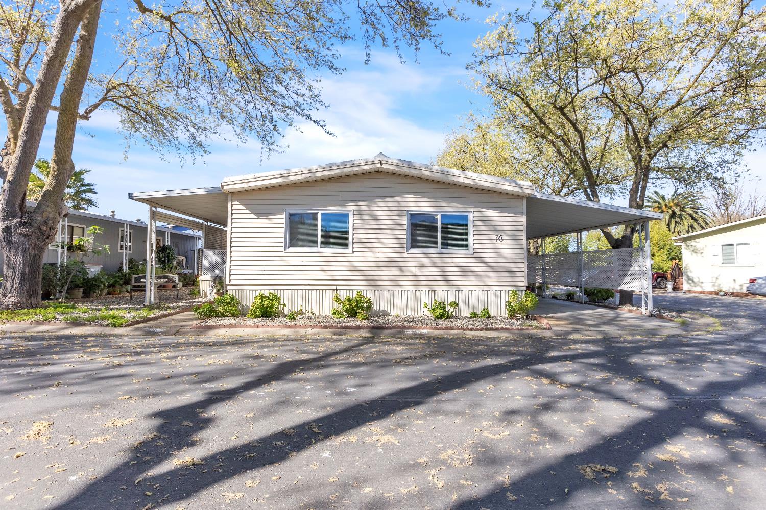 3901 Lake Road, Unit 76 West Sacramento, CA 95691 - Photo 24 of 29 a front view of a house with a yard and garage