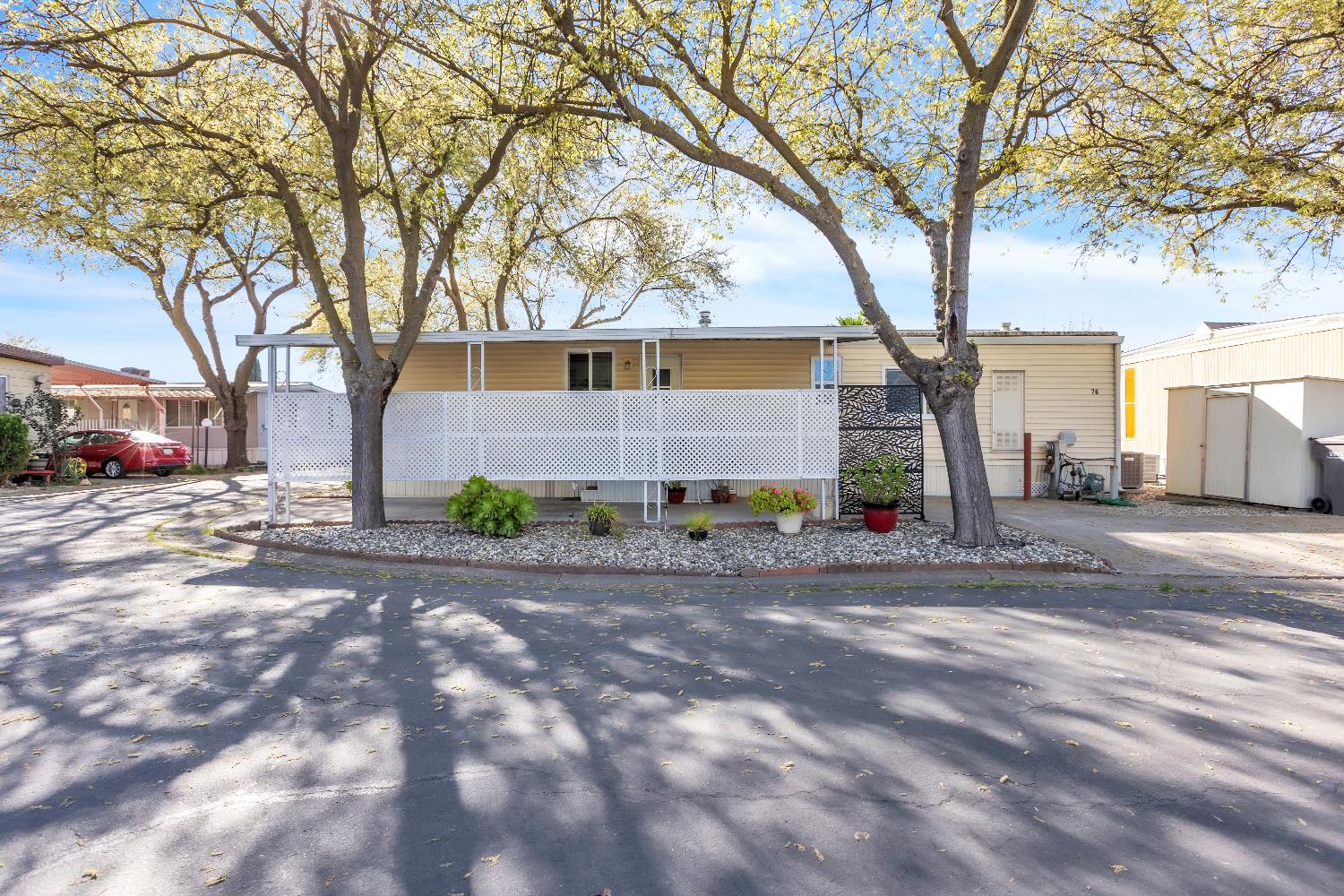 3901 Lake Road, Unit 76 West Sacramento, CA 95691 - Photo 26 of 29 a backyard of a house with large trees and outdoor seating