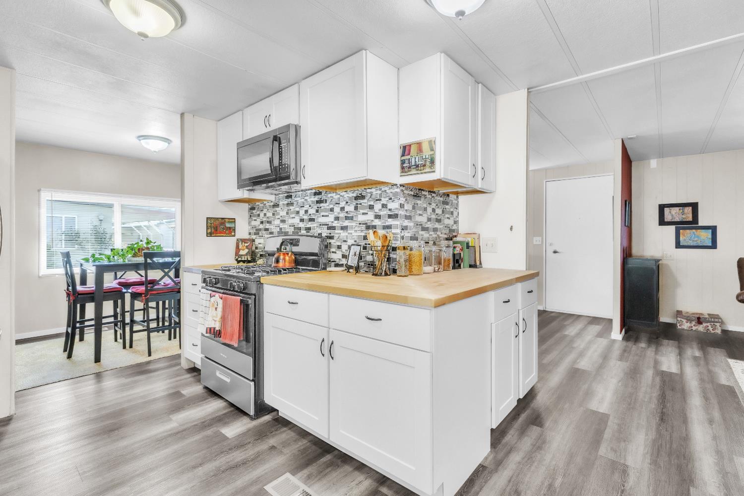 3901 Lake Road, Unit 76 West Sacramento, CA 95691 - Photo 10 of 29 a kitchen with stainless steel appliances white cabinets and wooden floor