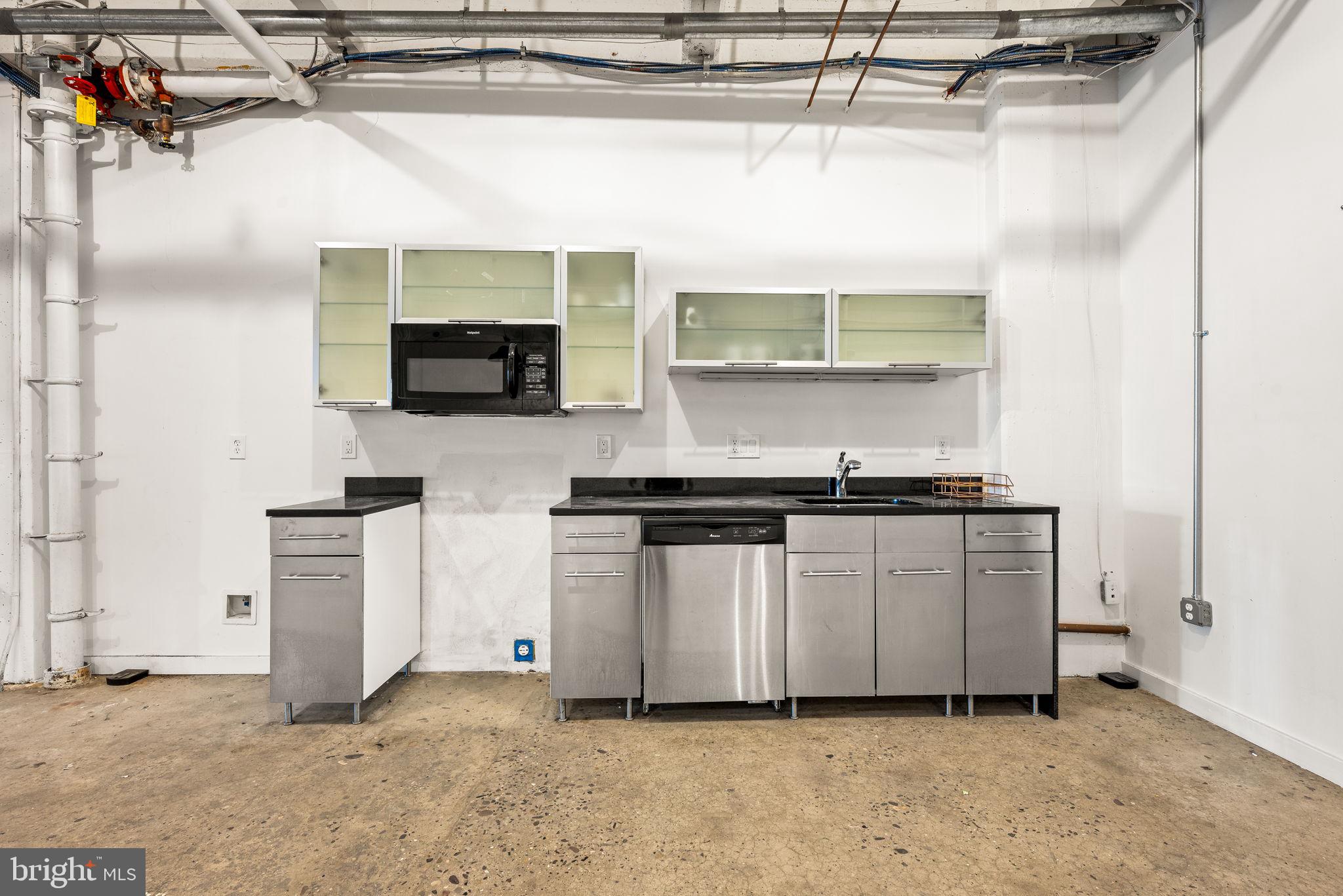 20 North 3rd Street, Unit 201 Philadelphia, PA 19106 - Photo 4 of 11 a kitchen with stainless steel appliances granite countertop a sink and a stove