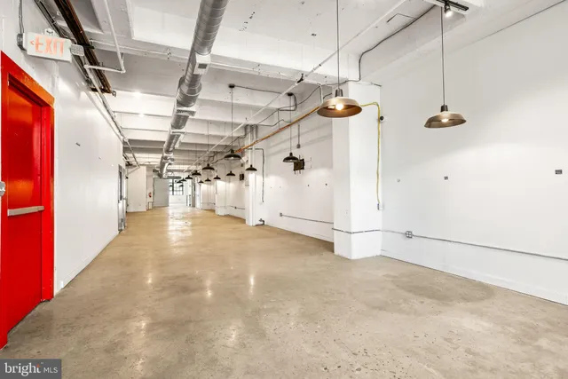 a living room with stainless steel appliances kitchen island granite countertop furniture and a fireplace