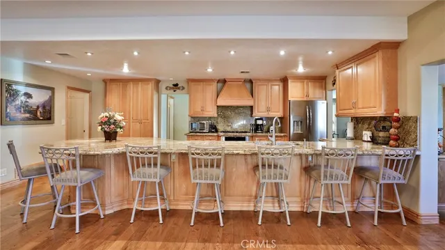 a large kitchen with stainless steel appliances lots of counter space and a sink