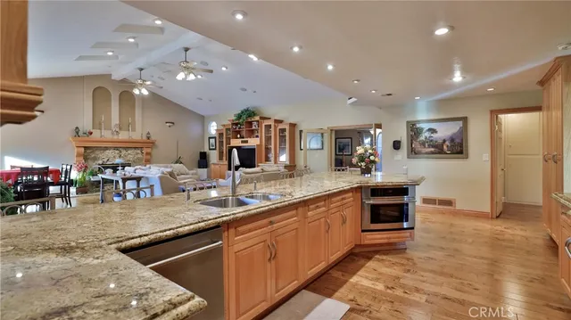 a living room with furniture a large window and wooden floor