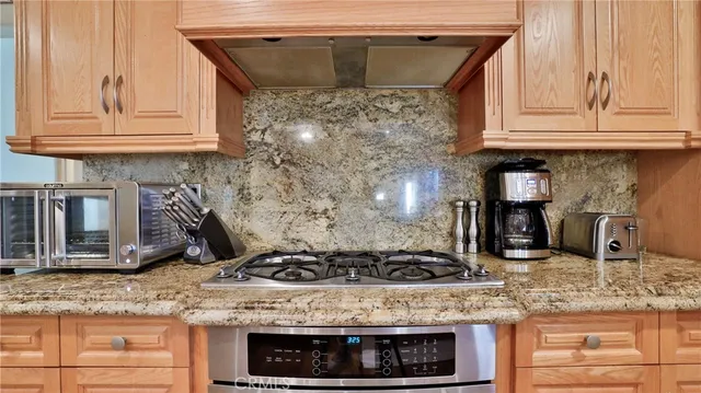 a living room with furniture kitchen view and a wooden floor