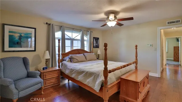 a bedroom with a bed lamp and a window