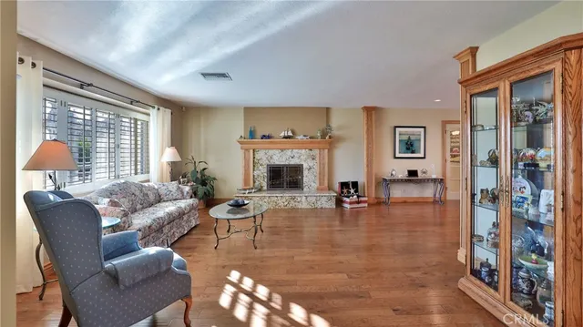a living room with furniture large window and a fireplace