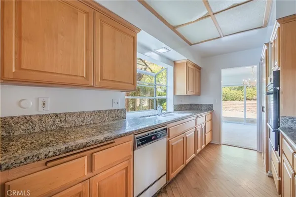 a kitchen with stainless steel appliances granite countertop a stove and a sink