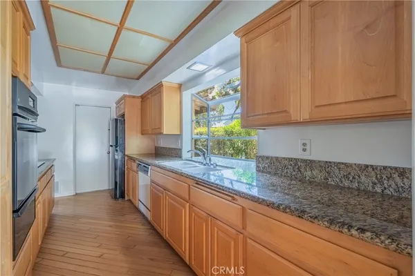 a kitchen with stainless steel appliances granite countertop a refrigerator and a stove