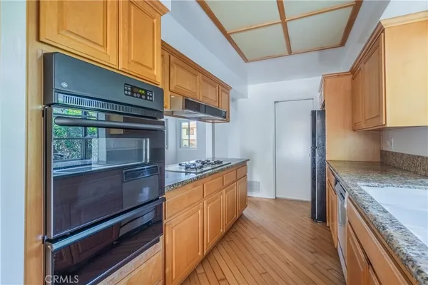 a kitchen with granite countertop a sink and a window
