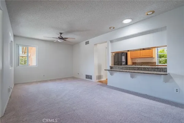 a view of an empty room with windows