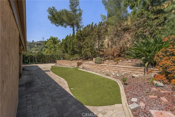 a view of a house with a yard and sitting area