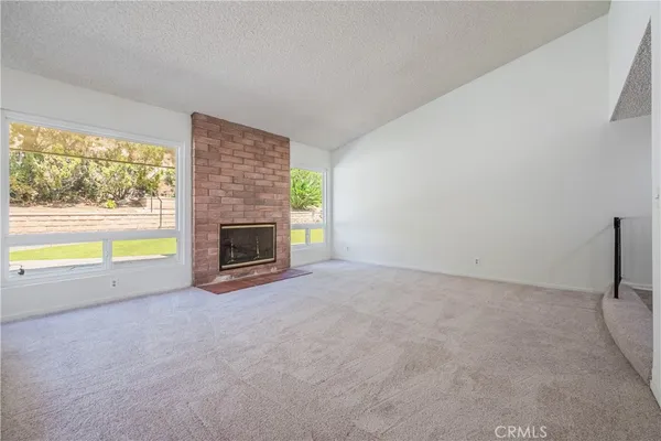 a view of an empty room with windows