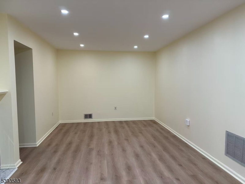 604 Bayley Court Bridgewater, NJ 08807 - Photo 2 of 15 an empty room with wooden floor and white walls