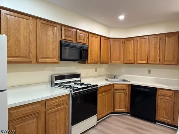 a kitchen with stainless steel appliances granite countertop a sink stove and microwave