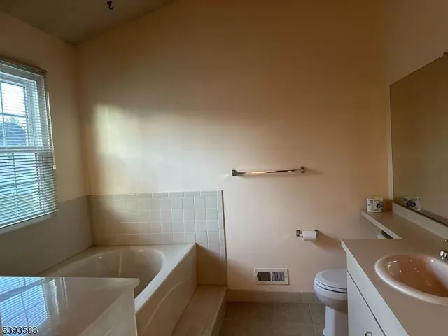 a bathroom with a sink a toilet and bathtub