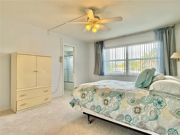 a bedroom with a bed a dresser and a window