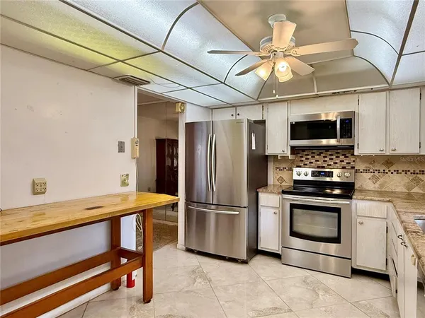 a kitchen with a sink appliances and cabinets