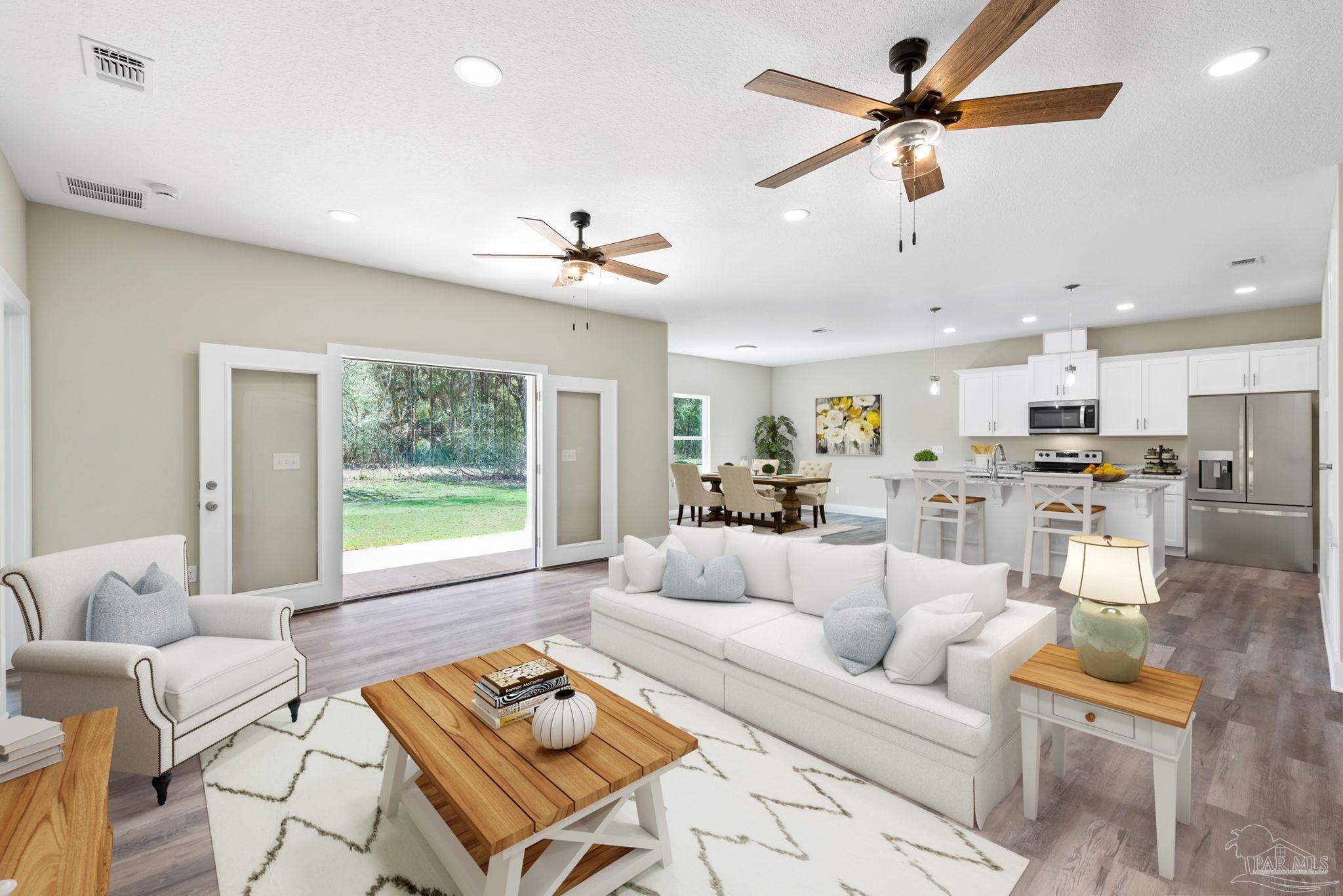 8261 Larson Lane Milton, FL 32583 - Photo 14 of 47 a living room with furniture and a large window with kitchen view
