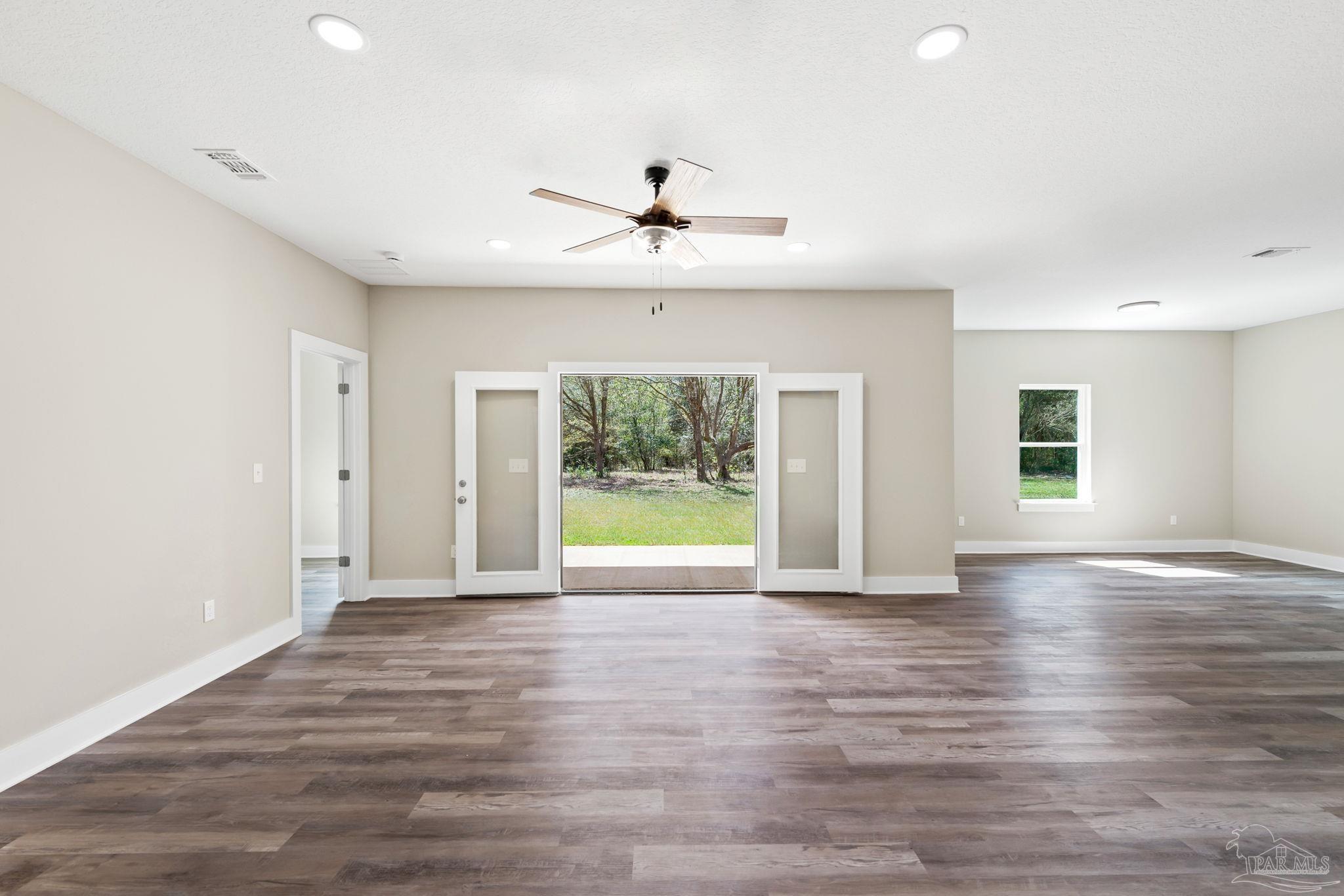 8261 Larson Lane Milton, FL 32583 - Photo 15 of 47 wooden floor in an empty room with a window