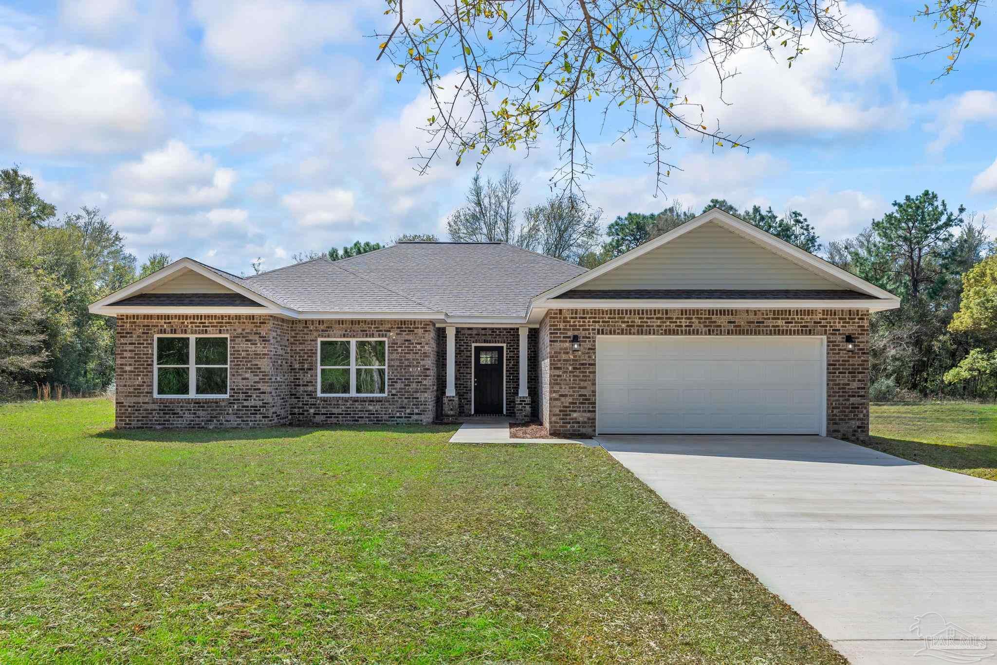 8261 Larson Lane Milton, FL 32583 - Photo 2 of 47 a front view of a house with yard and green space