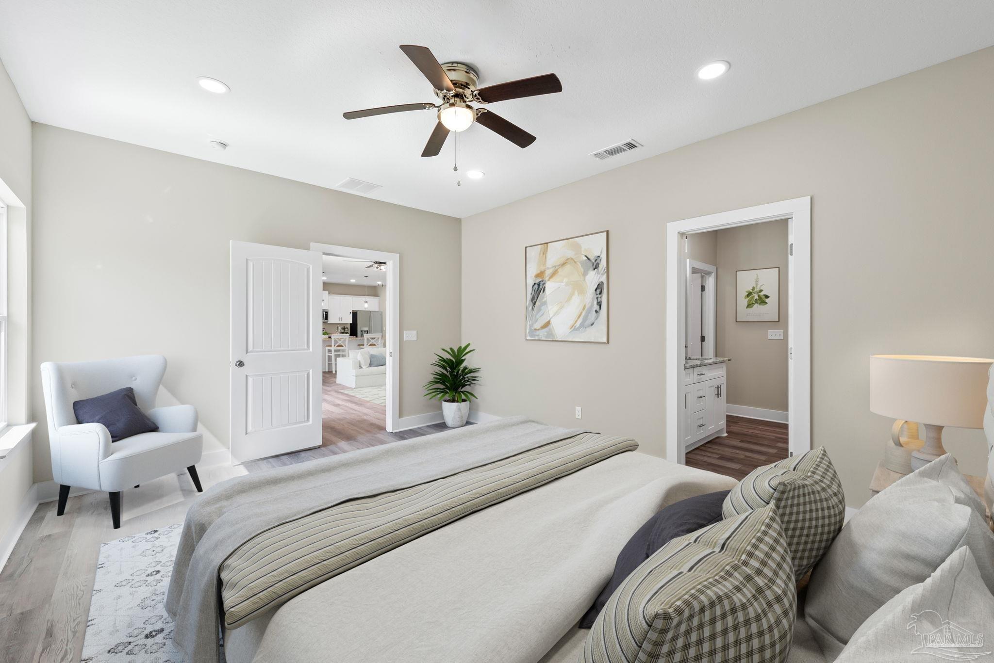 8261 Larson Lane Milton, FL 32583 - Photo 30 of 47 a bedroom with a large bed and a couch