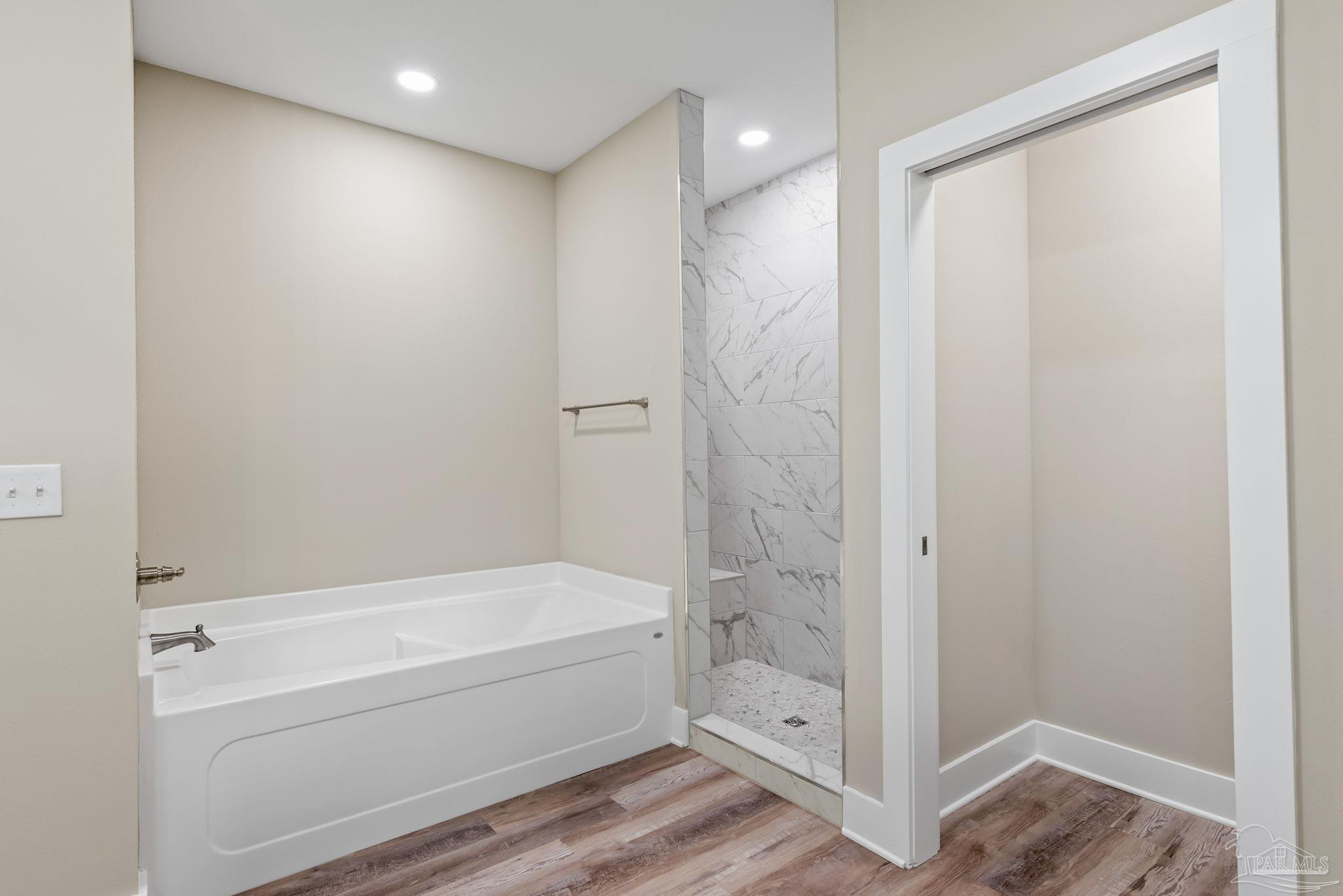 8261 Larson Lane Milton, FL 32583 - Photo 35 of 47 a bathroom with a bathtub and a shower