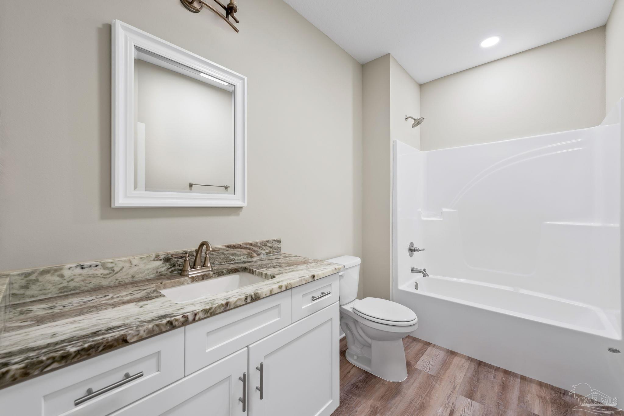 8261 Larson Lane Milton, FL 32583 - Photo 42 of 47 a bathroom with a granite countertop sink a toilet and shower