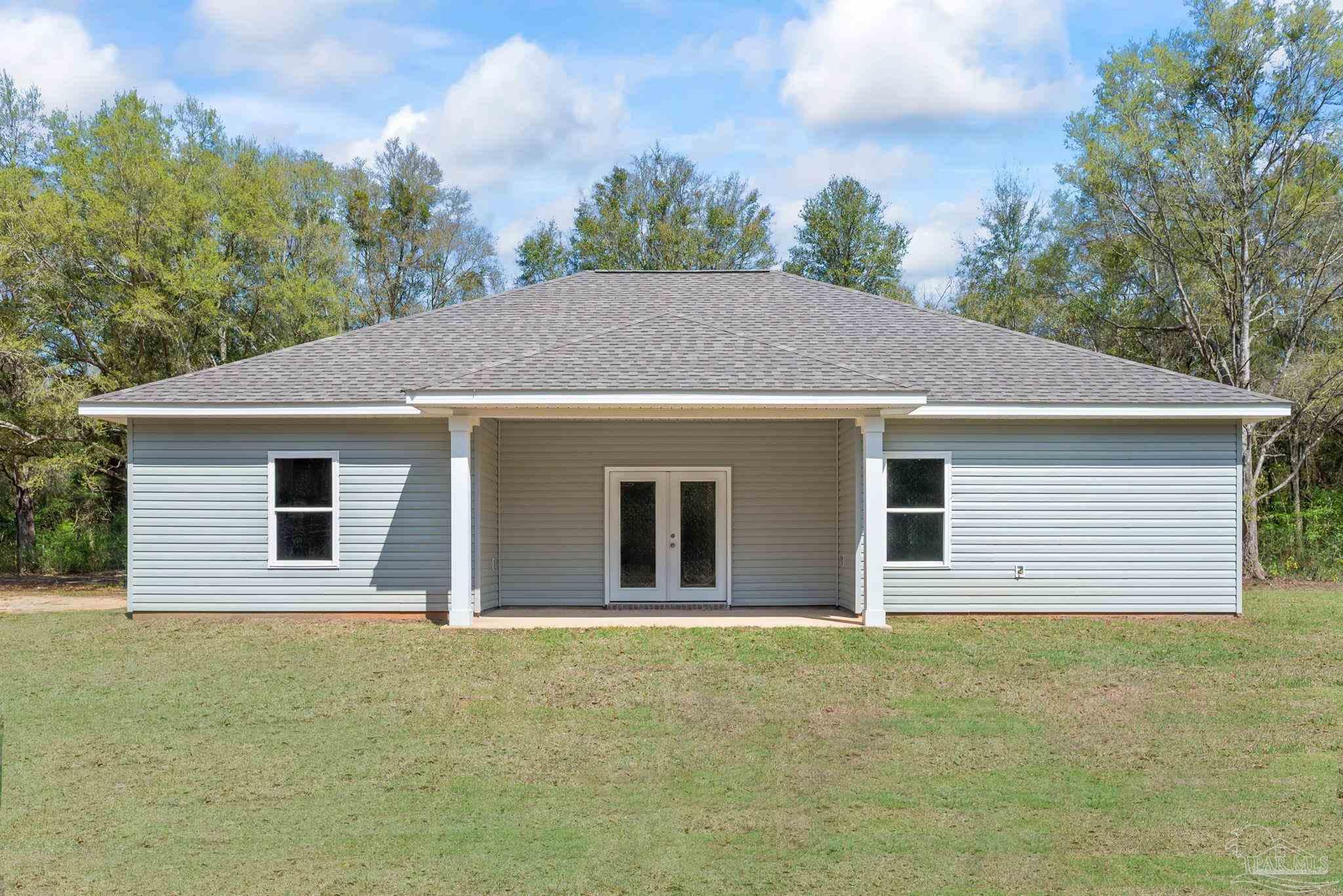 8261 Larson Lane Milton, FL 32583 - Photo 6 of 47 a house with trees in the background