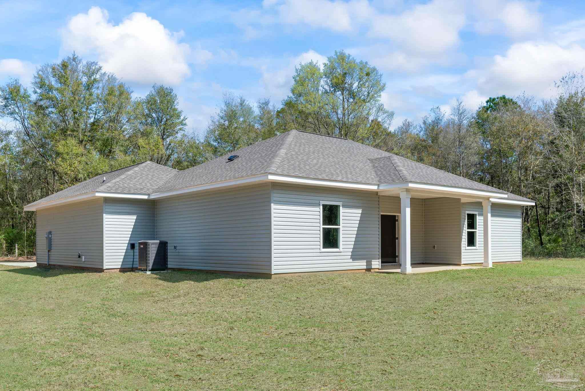 8261 Larson Lane Milton, FL 32583 - Photo 7 of 47 a view of a house with a backyard