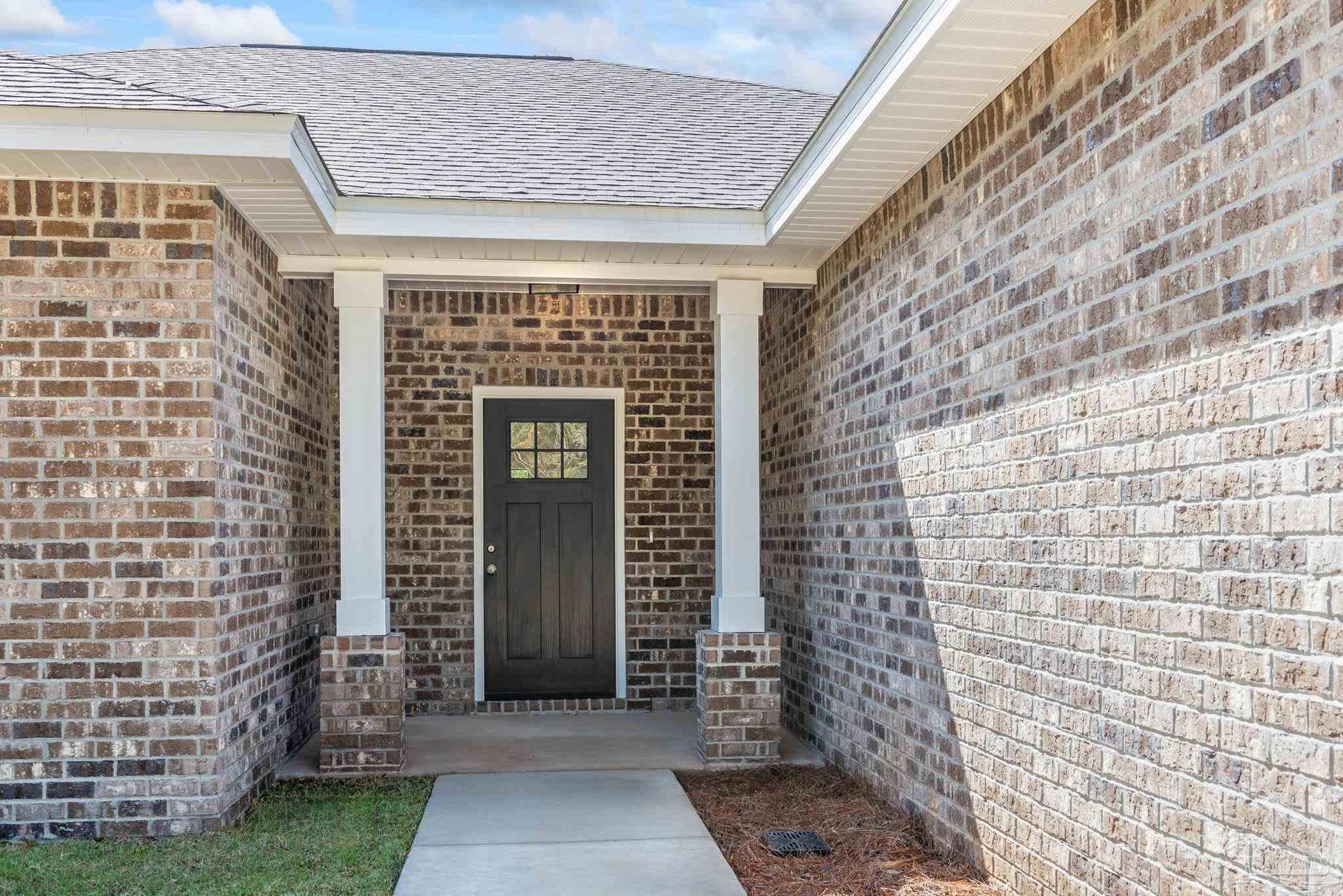 8261 Larson Lane Milton, FL 32583 - Photo 10 of 47 a front view of a house with brick walls