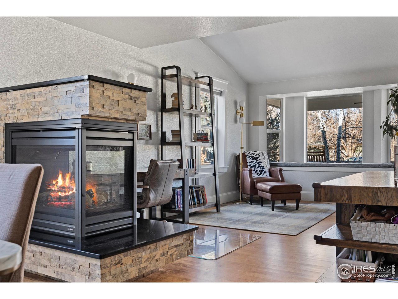 1201 Juniper Court Fort Collins, CO 80521 - Photo 11 of 50 a living room with furniture a window and a fireplace