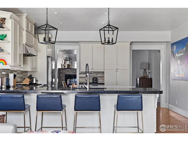 a kitchen with stainless steel appliances a sink stove and cabinets