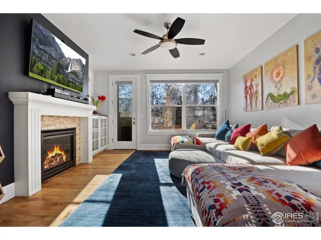 a living room with a fireplace and a flat screen tv