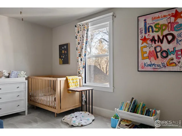 a living room with furniture and a wall painting