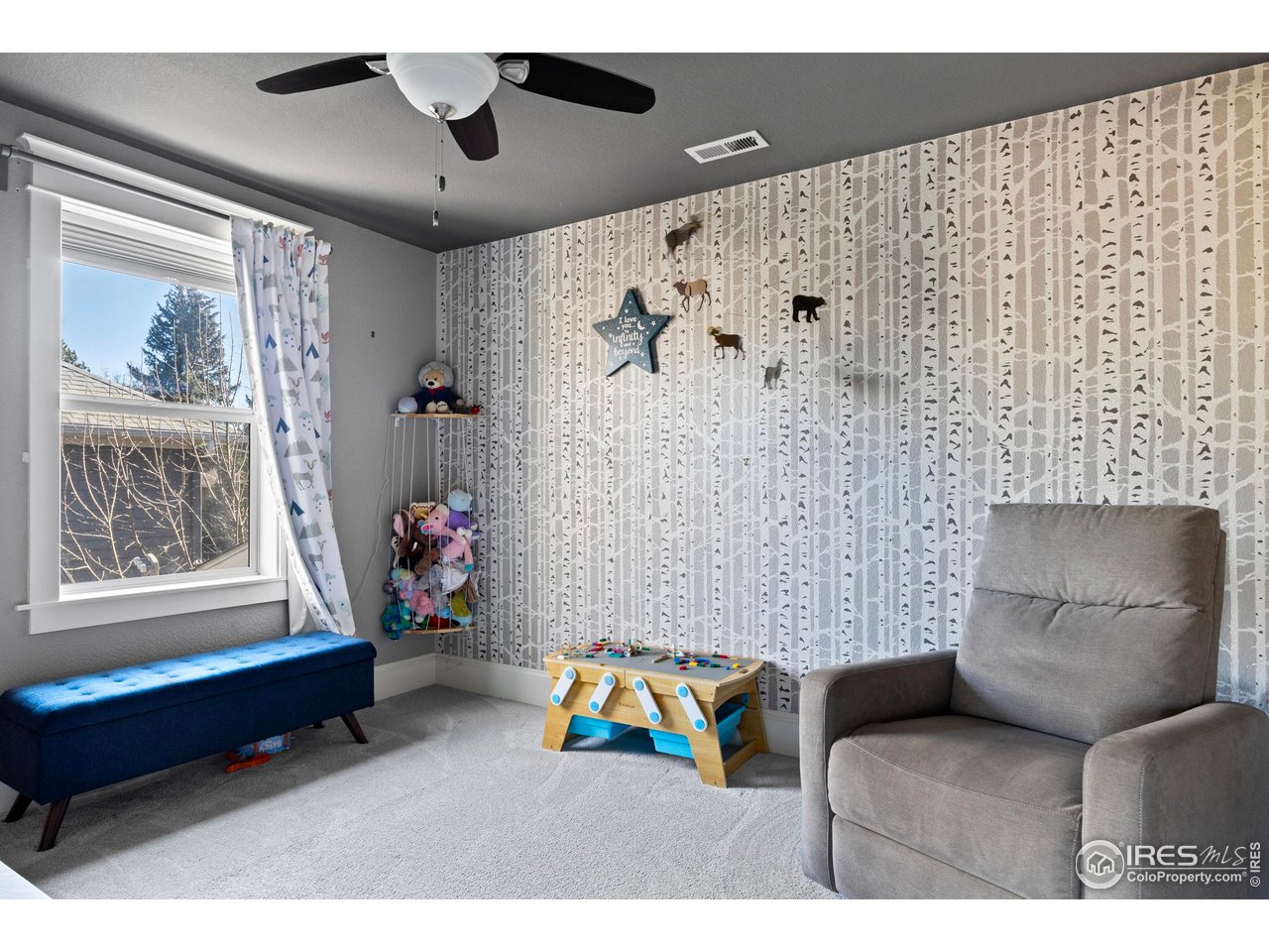1201 Juniper Court Fort Collins, CO 80521 - Photo 34 of 50 a living room with furniture and a wall painting