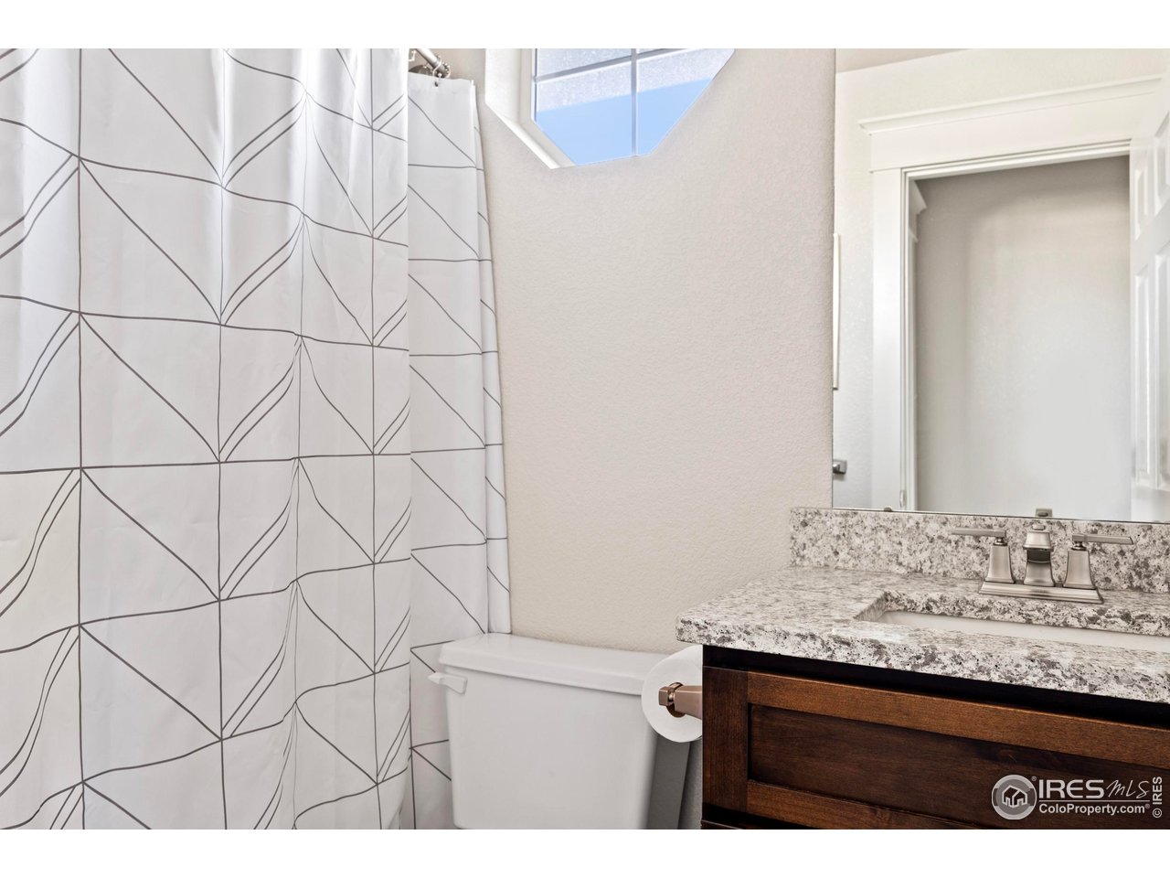 1201 Juniper Court Fort Collins, CO 80521 - Photo 35 of 50 a bathroom with a granite countertop sink and a mirror