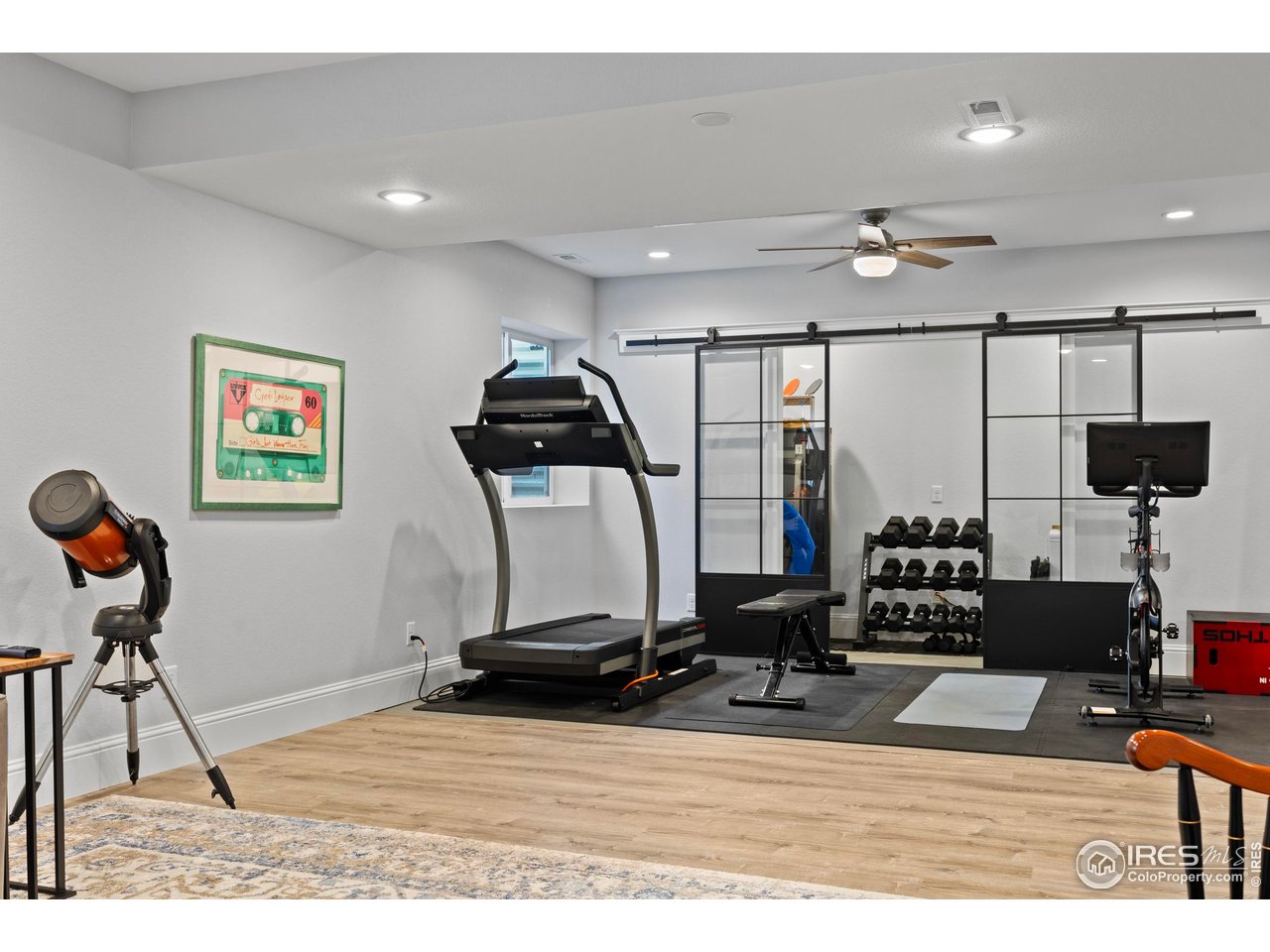 1201 Juniper Court Fort Collins, CO 80521 - Photo 36 of 50 a room with gym equipment and view of living room