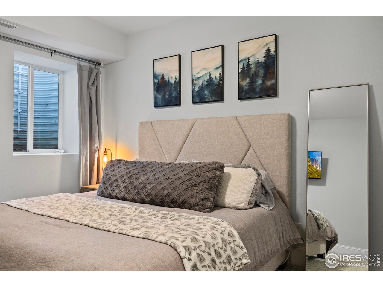 1201 Juniper Court Fort Collins, CO 80521 - Photo 39 of 50 a bedroom with a bed and wooden floor